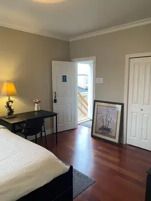 a bedroom with a bed and a desk with a lamp at A cozy independent entrance bedroom with a private washroom close to YVR Richmond in Richmond