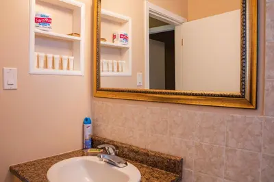 a bathroom with a sink and a mirror at Lakeview Motel in Christina Lake