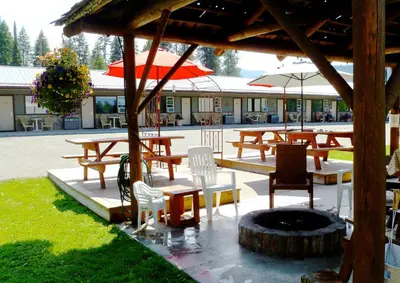a group of tables and chairs and a fire place at Lakeview Motel in Christina Lake