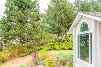 a view of a garden from the side of a house at Cozy 5BD House in North Mission Crawford in Kelowna
