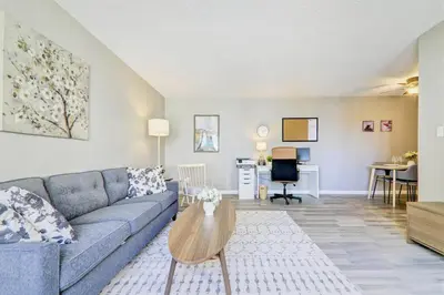 a living room with a couch and a table at Roomy Top Floor at Stampede w Free Parking and AC in Calgary
