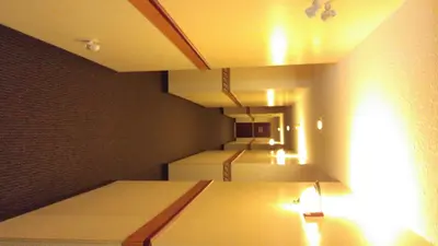 a room with two beds and a wall with lights at Crossfield Country Inn in Crossfield