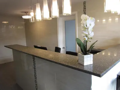 a kitchen with a counter with a vase of flowers at Rest Inn in Terrace