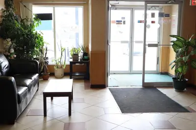 a living room with a couch and a coffee table at Destination Family Hotel in Whitehorse