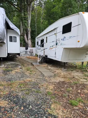 two white rvs parked next to each other at Comfortable RV in a farm in Nanoose Bay