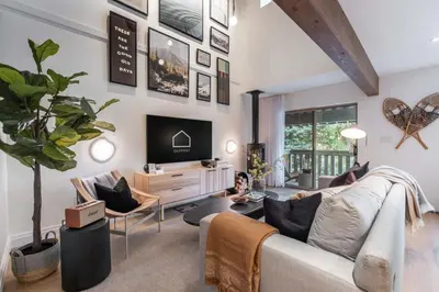 a living room with a couch and a tv at Forest Trails by Outpost Whistler in Whistler