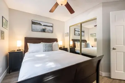 a bedroom with a large bed and a mirror at Powderview by Outpost Whistler in Whistler