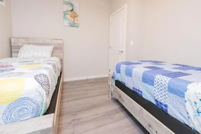 a bedroom with a bed and a mirror at Cozy Springs in Calgary