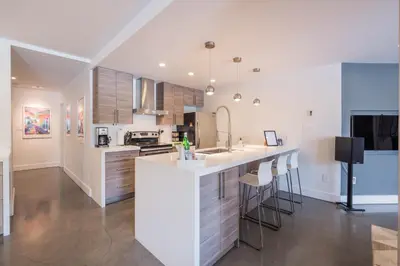 a kitchen with white cabinets and a counter top at Gleneagles by Outpost Whistler in Whistler