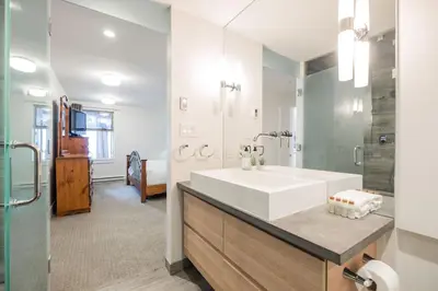 a bathroom with a white sink and a mirror at Gleneagles by Outpost Whistler in Whistler