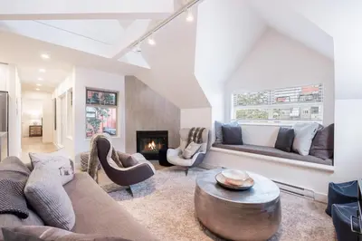a living room with a couch and a fireplace at Lake Placid Lodge by Outpost Whistler in Whistler