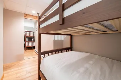 a bedroom with two bunk beds and a hallway at Mountain Star by Outpost Whistler in Whistler