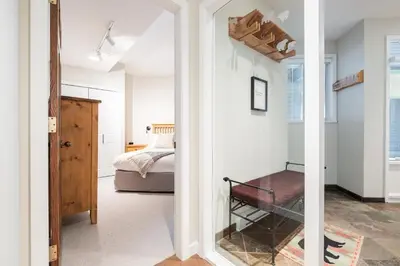 a room with a bed and a glass door leading to a bedroom at Lynx by Outpost Whistler in Whistler