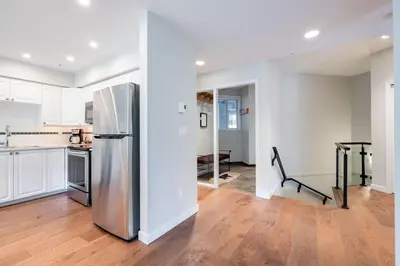 a kitchen with a stainless steel refrigerator in a room at Lynx by Outpost Whistler in Whistler