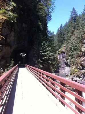 a red bridge over a river with a tunnel at Evergreen Bed & Breakfast in Hope