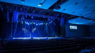 an empty auditorium with blue lights in a theatre at Grey Eagle Resort in Calgary