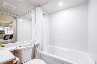 a bathroom with a toilet and a sink and a mirror at Glacier's Reach by Outpost Whistler in Whistler