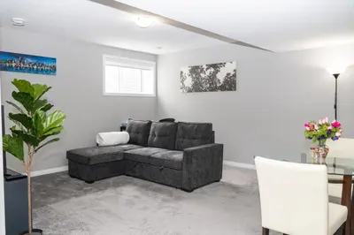 a living room with a couch and a table at The Jade Place in Airdrie