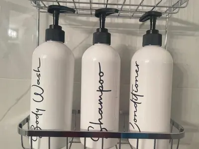 three white bottles on a rack in a refrigerator at Private Chic Modern Suite with Kitchen near Spruce Meadows and LRT in Calgary