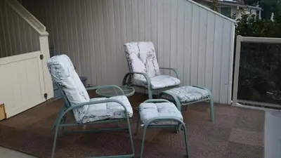 two chairs and a table on a patio at Casa Loma BnB in West Kelowna