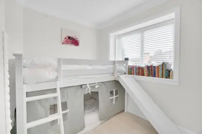 a white bunk bed in a white room with a window at Family-Friendly, 3 Bed House - Private Backyard-Central Location in Vancouver