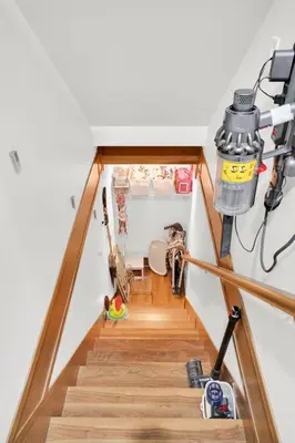 a staircase in a house with wood floors at Family-Friendly, 3 Bed House - Private Backyard-Central Location in Vancouver