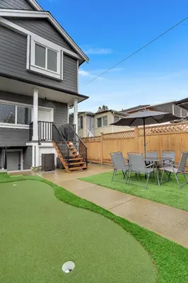 a patio with chairs and a table and an umbrella at Family-Friendly, 3 Bed House - Private Backyard-Central Location in Vancouver