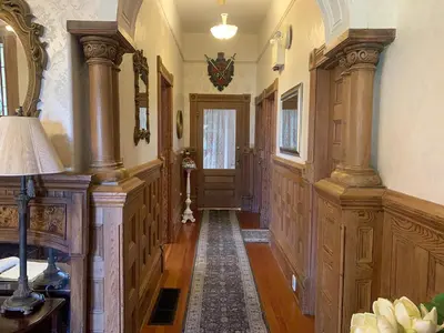 a hallway of a home with wood paneling and a door at Haterleigh Heritage Inn in Victoria