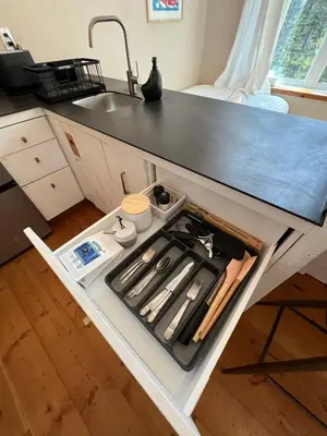 a kitchen island with a stove and a sink at Black Spruce - Orange Door in Whitehorse