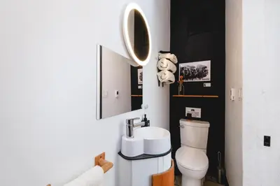 a bathroom with a white toilet and a sink at Black Spruce - Yellow Door in Whitehorse