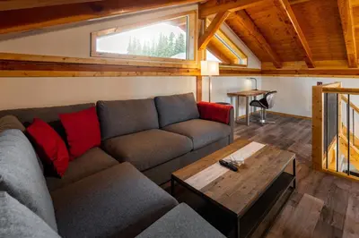a living room with a couch and a table at Red Cariboo Resort in Anahim Lake