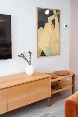 a living room with a table and a painting on the wall at Sea Eagles Landing by Revelstoke Vacations in Revelstoke