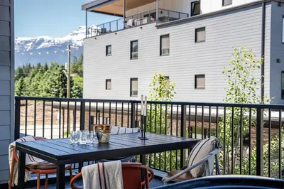 a black table and chairs on a balcony at Sea Eagles Landing by Revelstoke Vacations in Revelstoke