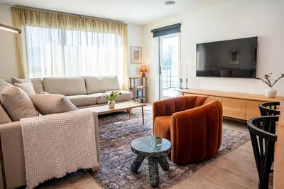 a living room with a couch and a tv at Sea Eagles Landing by Revelstoke Vacations in Revelstoke