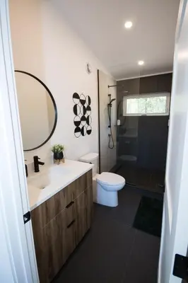 a bathroom with a sink and a toilet and a mirror at Luxury Private Cabin In The Rockies in Golden