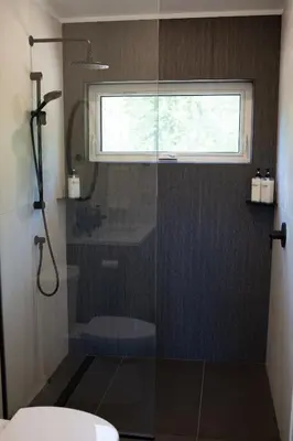 a bathroom with a shower with a window at Luxury Private Cabin In The Rockies in Golden