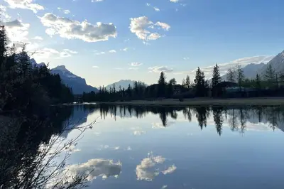 a view of a lake with clouds in the water at unit #303 Mountain view 1BR in Canmore DownTown in Canmore
