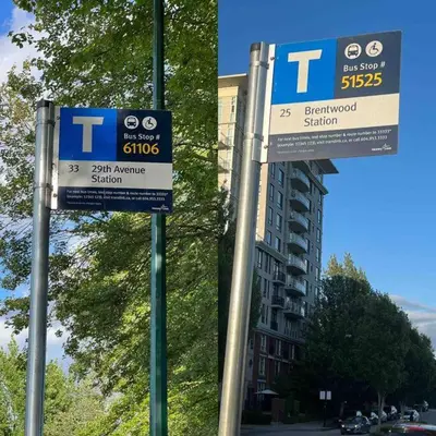 two blue and white signs on a city street at Newly Renovated Walkout Basement in Vancouver with Separate Entrance in Vancouver