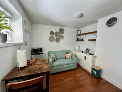 a kitchen with a table and a chair in a room at Newly Renovated Walkout Basement in Vancouver with Separate Entrance in Vancouver