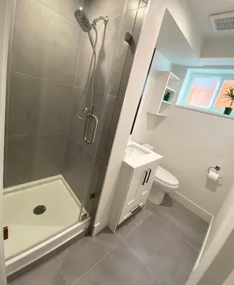 a bathroom with a shower and a toilet at Newly Renovated Walkout Basement in Vancouver with Separate Entrance in Vancouver