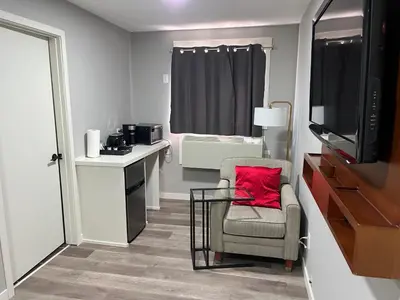 a small room with a chair and a television at Bethel hotel Elk Point in Elk Point