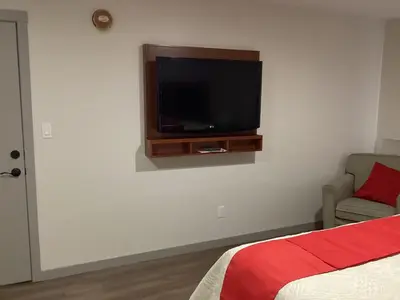 a bedroom with a flat screen tv on the wall at Bethel hotel Elk Point in Elk Point