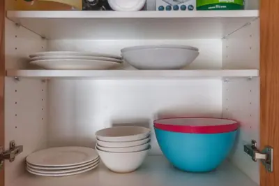 a shelf with bowls and plates in a kitchen at The Ridge Ski-In Ski-Out Condo with Free Parking in Big White