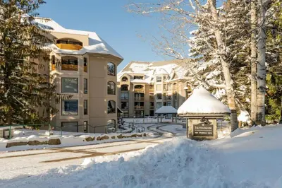 a building with a gazebo in the snow at The Maple Ski-in Ski-out 1 Bed with Hot Tub and Pool in Whistler