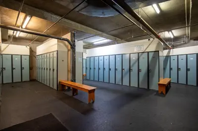 an empty locker room with benches and lockers at The Maple Ski-in Ski-out 1 Bed with Hot Tub and Pool in Whistler