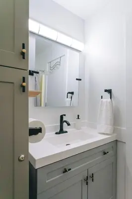 a bathroom with a sink and a large mirror at The Fjall Ski-In Ski-Out Village Studio in Big White