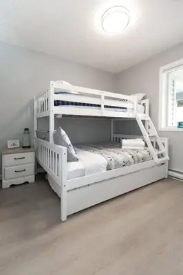 a bedroom with two bunk beds in a room at Lovely 2 bedroom suite steps from The beach in Victoria