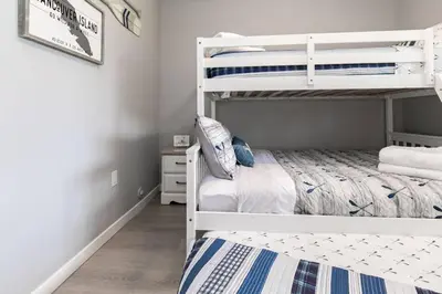 a bedroom with two bunk beds in a room at Lovely 2 bedroom suite steps from The beach in Victoria