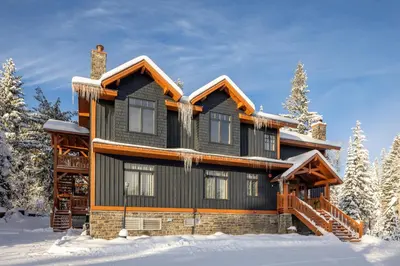 a house in the winter with snow on the ground at Copper Horse Lodge in Golden