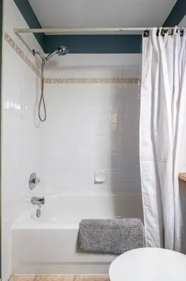 a bathroom with a white tub and a shower at R&R Relaxation Ridge, Private Hot Tub, Spacious in Radium Hot Springs